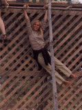 Barefoot Girl Swinging on Structure Containing Baby Chicks in Coop, Woodstock Music and Art Fair
