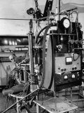 Italian Physicist Enrico Fermi Peering Out from Behind Large, Complicated Machinery in Laboratory