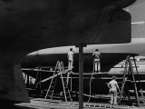 Three Workmen Repairing the America's Cup Contender the Constellation at and Unidentified Boat Yard
