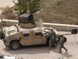 US Military Soldiers Take a Well Earned Break in the Forground of the Baghdad Hotel