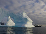 National Geographic Endeavour Framed in a Beautiful Iceberg Arch, Antarctic Peninsula, Antarctica