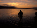 Silhouette of a Man Creating Ripples Along the Shoreline, North Slope, Alaska