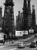 Buy Car Traffic on Highway Next to Advertising Billboards and Oil Well Towers, Signal Hill Oil Field at AllPosters.com