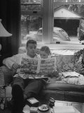 Buy Father Sitting on Couch with Pigtailled Daughter Reading to Her the Sunday Comic Pages at AllPosters.com