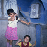 Two Small Uzbek Girls Using the Public Telephone in Bukhara, Uzbekistan, Central Asia