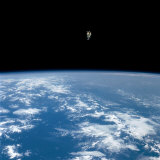 An astronaut propelled above the earth with a nitrogen jet backpack