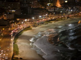 Buy Curving highway and ocean shoreline reflect colorful lights at AllPosters.com