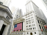 The facade of the New York Stock Exchange draped in the American Flag