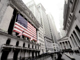 The facade of the New York Stock Exchange draped in the American Flag