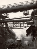 Steaming Hot Steel Slag Being Poured into Freight Cars on Railroad Siding at Steel Plant