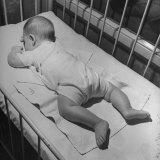 Buy Baby Sleeping on its Stomach in Nursery at St. Vincent's Hospital at AllPosters.com