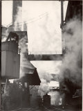 Steaming Hot Steel Slag Being Poured into Freight Cars on Railroad Siding at Steel Plant