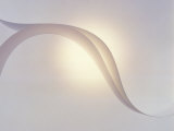 Two White Fabric Streamers Drifting in Pale Grey Sky with Strong Backlight
