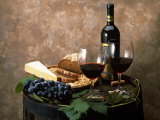 Still Life of Wine Bottle, Wine Glasses, Cheese and Purple Grapes on Top of Barrel