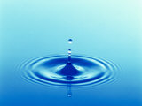 Drops Rising from Ripples in Blue Water