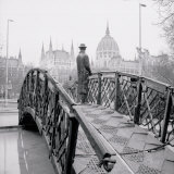 Statue of Prime Minister Imre Nagy Standing on a Footbridge with the Parliament Building