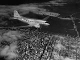 Buy Plane Flying over a City from a Story Concerning United Airlines at AllPosters.com