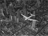 Aerial View of a Dc-4 Passenger Plane in Flight over Manhattan