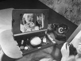 Woman Using a Swing Table to Put on Her Make-Up