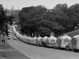 Long Line of Airstream Trailers Wait for Parking Space at a Campground During a Trailer Rally