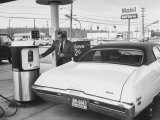 Buy Motorist Filling Up His Own Car at a Self Service Gas Station at AllPosters.com