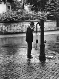 Man Drinking from Public Water Pump Fountain on Street, Frankfort-On-The-Main, Germany