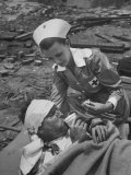 The Red Cross Nurse Trying to Help the Injured Man Eat and Drink