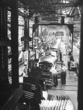 Employees Working on Cars as They Move Down Assembly Line