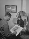 Cartoonist Charles Addams Using a Model for His Cartoon 