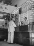 Buy Man Standing at Counter in Wing Lung Bank at AllPosters.com