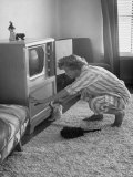 Young Woman Attending to Her Housework by Dusting Off Her Television Set