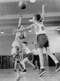 Young Boy Shooting a Free-Throw Shot over the Head of Another Young Boy