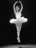 Ballerina Margot Fonteyn in White Costume Leaping into the Air While Dancing Alone on Stage