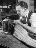 Man Sewing Strips of Fur Together
