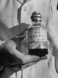 Nurse Holding a Bottle of Poison Ivy Oil