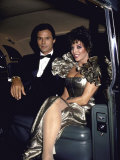 Actors Michael Nader and Joan Collins Sitting in a Car