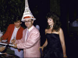 Buy Singer Songwriter Elton John Signing Book with Wife, Sound Engineer Renata Blauel, Looking On at AllPosters.com