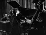 Singer Edith Piaf Holding Her Hands to Her Head While Performing with Pianist and Bass Player