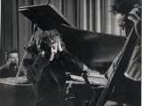 Singer Edith Piaf Holding Her Hands to Her Head While Performing with Pianist and Bass Player