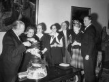 West German Chancellor Konrad Adenauer Cutting His Birthday Cake While Family Members Watch