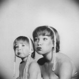 Actress Shirley Maclaine and Daughter Sachi Parker Pouting with String of Pearls on their Heads