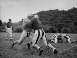 Coach Art Lewis Observing Four Young Football Prospects Blocking Each Other