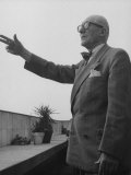 Buy Swiss-Born Architect Le Corbusier Standing on Terrace and Pointing Out Something in Distance at AllPosters.com