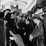 Folk Singer Woody Guthrie Playing His Guitar for Commuters on a Subway Train