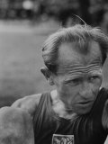 Emil Zatopek Sitting Tensely with Furrowed Brow after Winning Second of Three Olympic Races