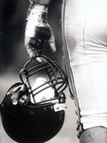 Low Angle View of an American Football Player Holding a Helmet