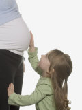 Buy Pregnant Woman with Daughter Touching Her Stomach at AllPosters.com