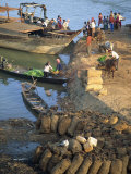 Buy Bags of Coal on the Shore and Boats in the Background at Stung Treng, Cambodia, Southeast Asia at AllPosters.com