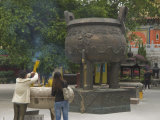 Worshippers at the Po Lin Monastery, Lantau Island, Hong Kong, China