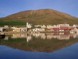 Reflections of Waterfront Buildings Including the Church and the Hill Behind at Husavik, Iceland